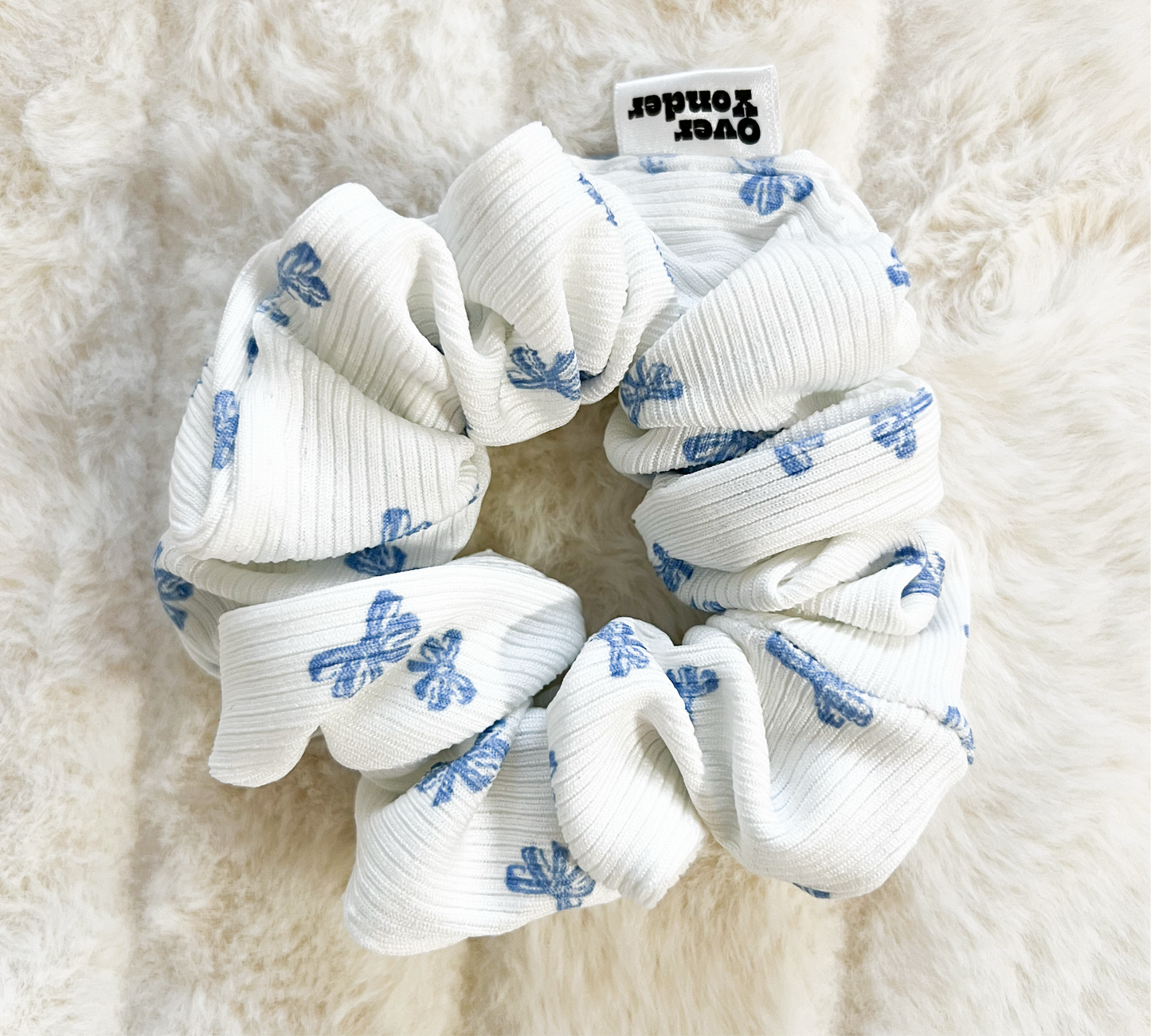 A knit scrunchie with light blue bow pattern